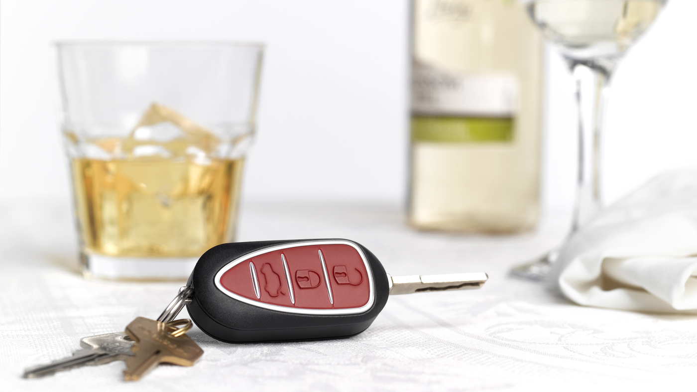 photo of car keys and alcohol